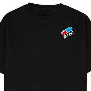 May include: Black short-sleeved t-shirt with a red and blue pill graphic and the word "DARE" printed below it.