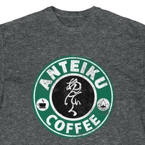 May include: A dark heather grey t-shirt with a green and white logo that says "ANTEIKU COFFEE" in a distressed font. The logo features a stylized Japanese character in the center.