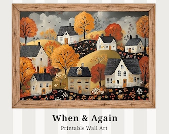 Puede incluir: Una impresión enmarcada que representa una escena de pueblo con casas blancas, tejados negros y árboles otoñales de color naranja. La obra de arte tiene un marco de madera rústico. El texto "When & Again Printable Wall Art" está en la parte inferior.