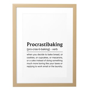May include: Framed print with the word "Procrastibaking" in black text. The definition is provided below, explaining the act of baking instead of doing boring tasks. The frame is a light brown color.