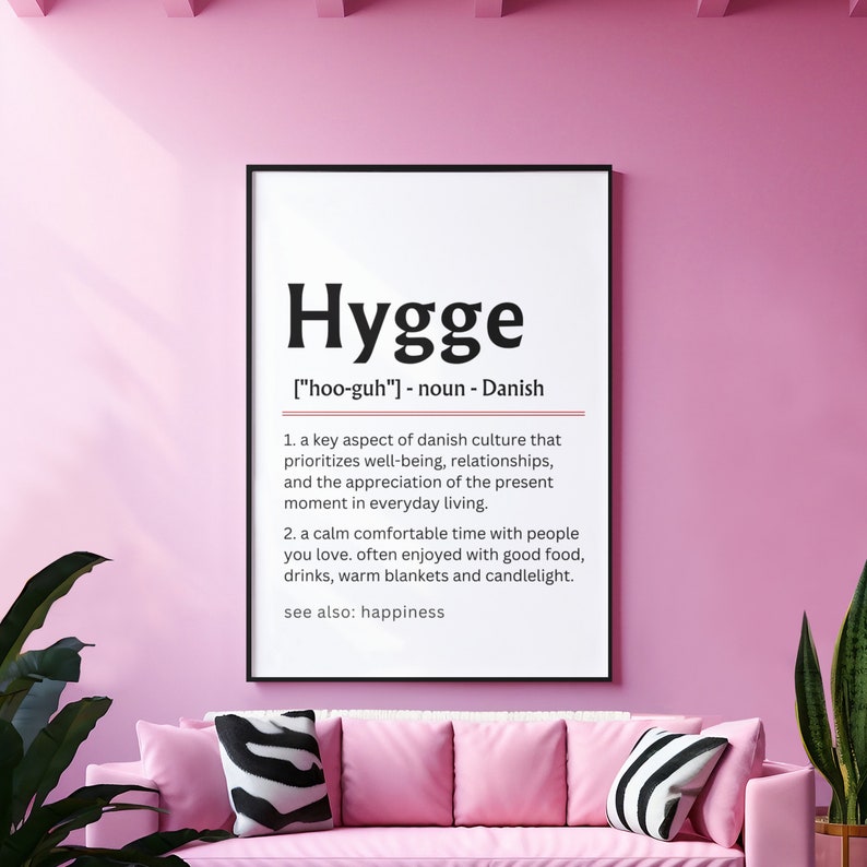 May include: A black and white print with the word "Hygge" in bold, defined as a Danish word meaning a key aspect of Danish culture that prioritizes well-being, relationships, and the appreciation of the present moment in everyday living. It also describes a calm comfortable time with people you love, often enjoyed with good food, drinks, warm blankets and candlelight. The print also says "see also: happiness".