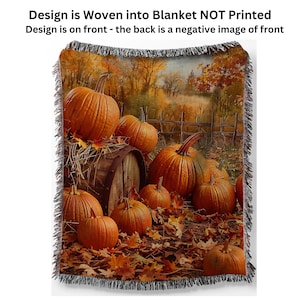 May include: A woven throw blanket with a fall theme featuring a barrel and pumpkins in a field of autumn leaves. The design is woven into the fabric, not printed.