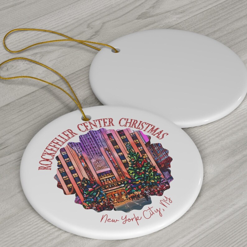 May include: White ceramic Christmas ornament with a red and white illustration of the Rockefeller Center Christmas tree and the text "Rockefeller Center Christmas New York City, NY".