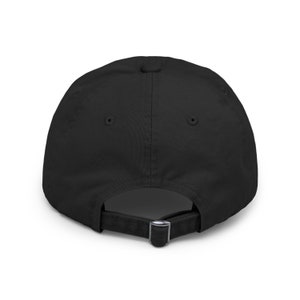 May include: Black baseball cap with a simple design. The cap has a curved brim and an adjustable strap in the back.
