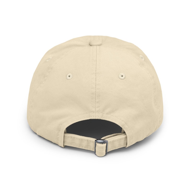 May include: A plain beige baseball cap with an adjustable strap in the back.