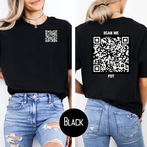 May include: Black t-shirt with a white QR code on the front and the text "SCAN ME" and a white QR code with the text "FDT" on the back.