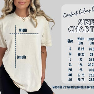 May include: A cream-colored t-shirt with a size chart, displaying measurements in inches. The chart includes sizes S to 4XL, with corresponding width and length measurements. The text "Comfort Colors C1717" is at the top. The model is wearing a medium.