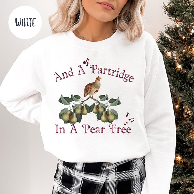 May include: White sweatshirt with a Christmas-themed design. The design features a partridge on a pear tree with the text "And A Partridge In A Pear Tree".