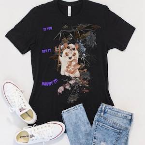 May include: Black t-shirt with a graphic of a ghost holding a gingerbread cookie with the text "If you got it haunt it!" printed in purple.