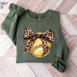 a green shirt with a baseball and a leopard print bow
