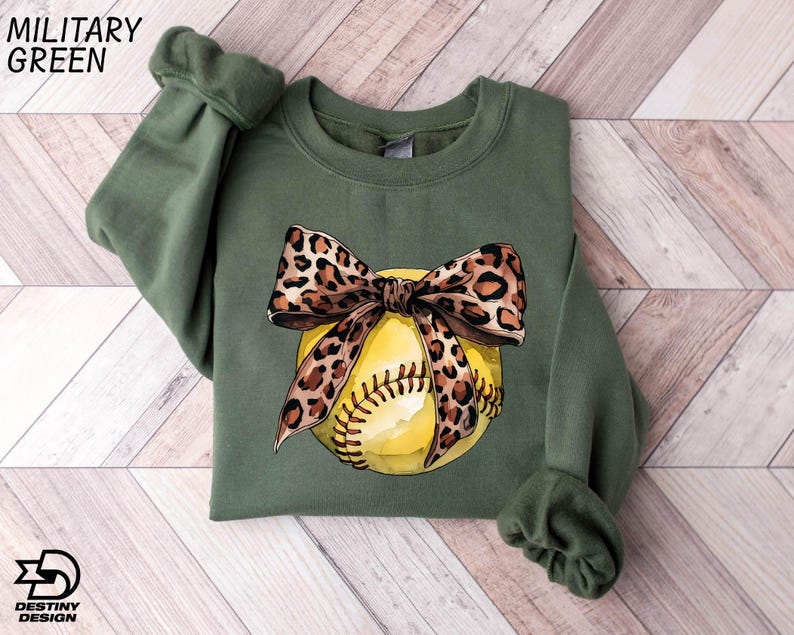 a green shirt with a baseball and a leopard print bow