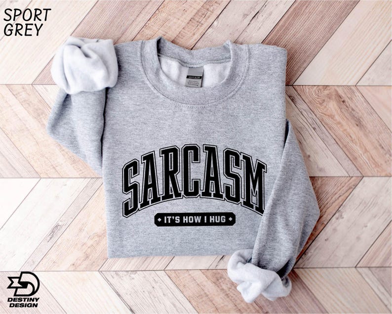 a gray sweatshirt with a black and white logo on it