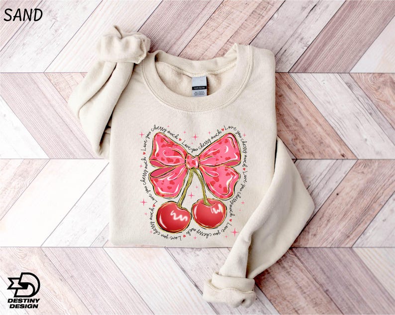 a sweater with a bow and cherries on it