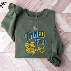a green sweatshirt with the words the tunad fish on it
