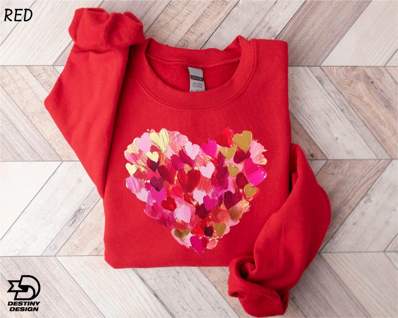 a red sweater with a heart made of hearts on it