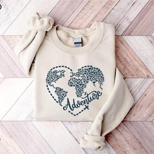 a sweater with the words adventure printed on it