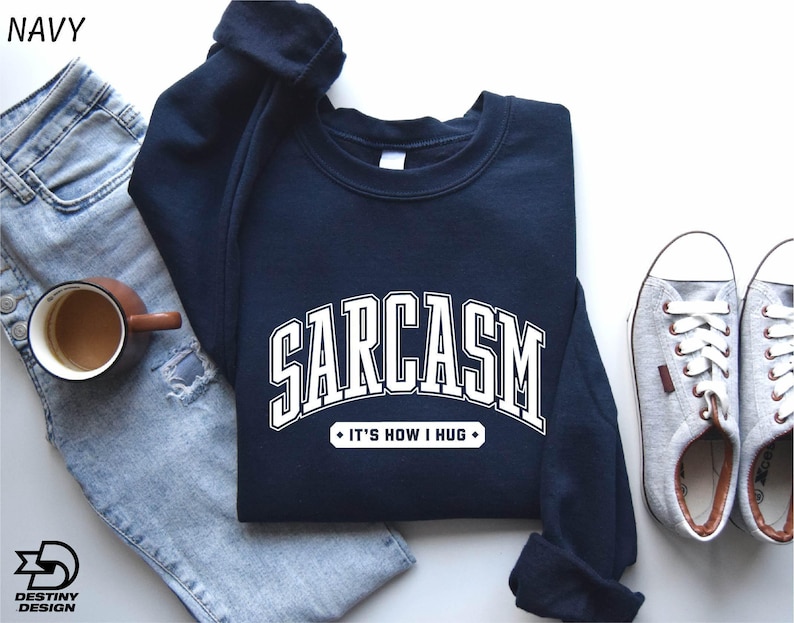 a pair of jeans, a sweatshirt, and a pair of sneakers