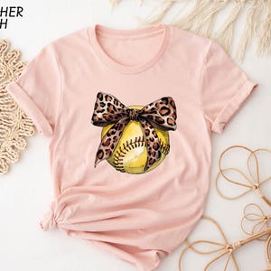a t - shirt with a softball and a bow on it