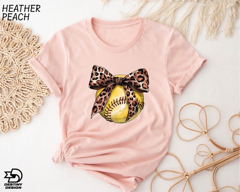a t - shirt with a softball and a bow on it