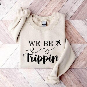 a sweater that says we be tripin on it