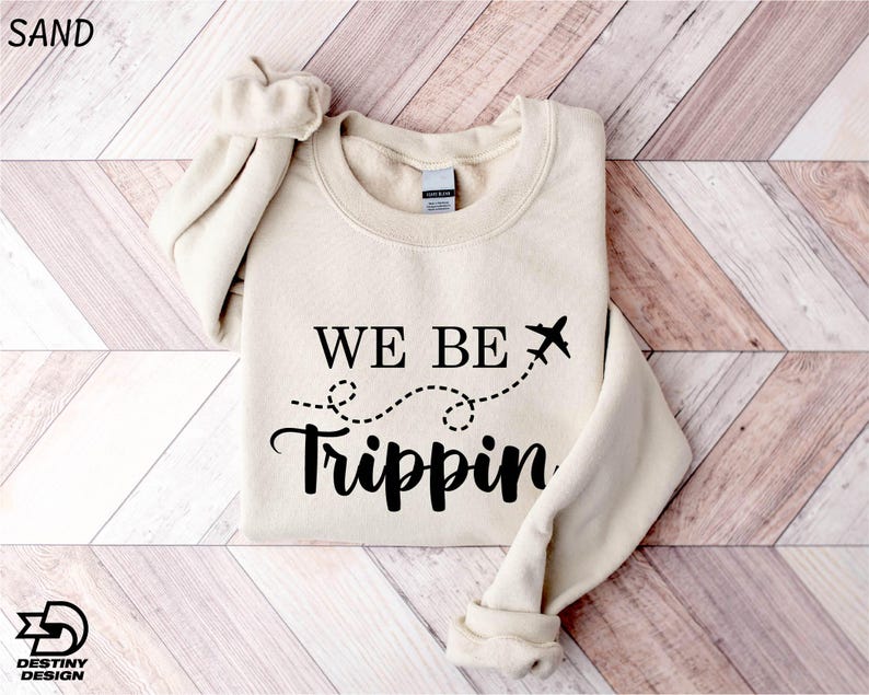 a sweater that says we be tripin on it