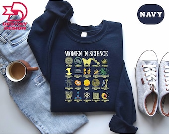May include: Navy blue sweatshirt with the text "WOMEN IN SCIENCE" and illustrations of scientists and scientific symbols. The sweatshirt also has the word "NAVY" in a navy blue oval.
