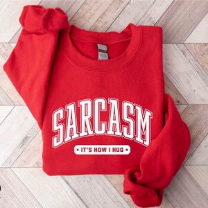 a red sweatshirt with the word sarcasm on it