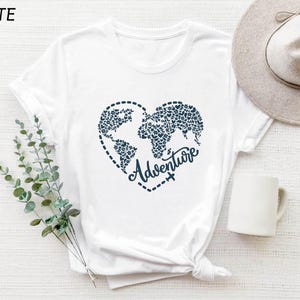 a white t - shirt with the words adventure written on it