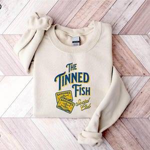a white sweatshirt with the words the tunad fish on it