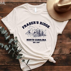 a white t - shirt with the words fraser's ridge on it