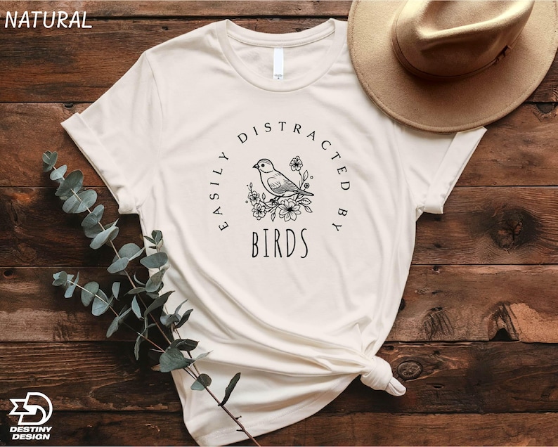 a white t - shirt with a bird on it