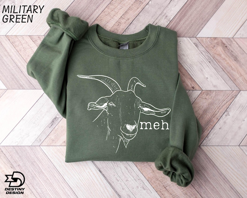 a green sweatshirt with a picture of a goat on it