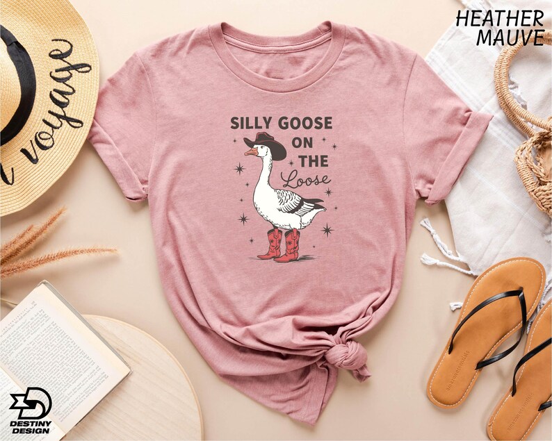 a pink shirt with a goose on the side