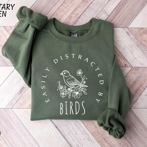 a green sweatshirt with a bird on it