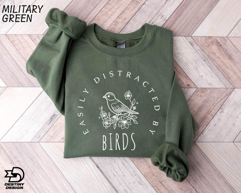 a green sweatshirt with a bird on it