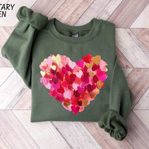 a green shirt with a heart made out of hearts