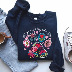 a pair of jeans and a t - shirt with a dog's paw on