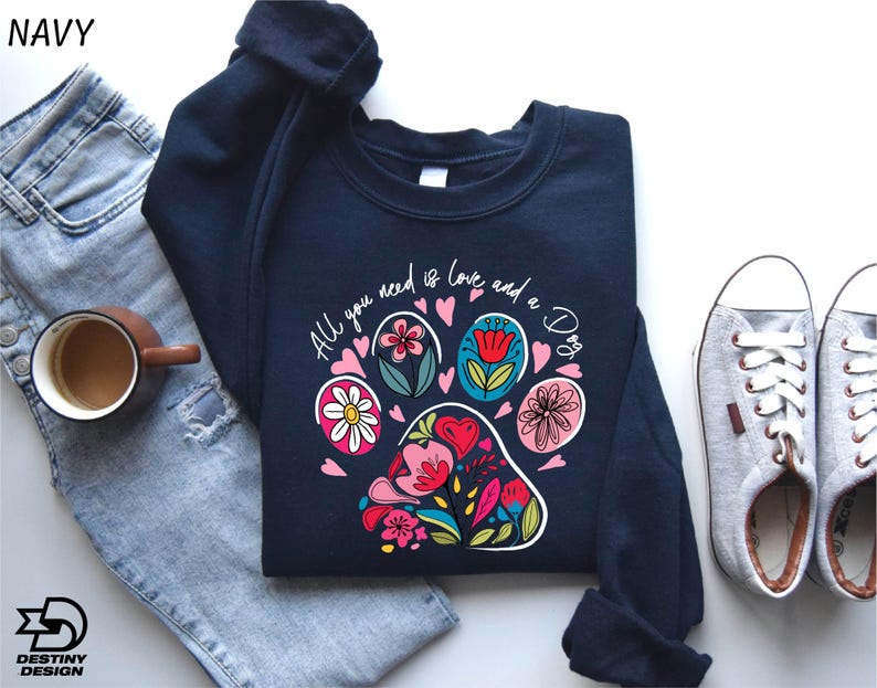 a pair of jeans and a t - shirt with a dog's paw on