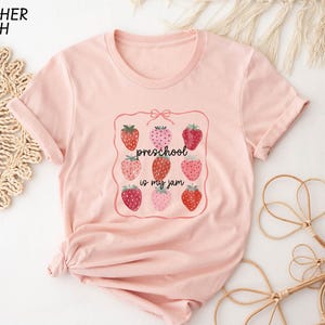a pink t - shirt with strawberries on it