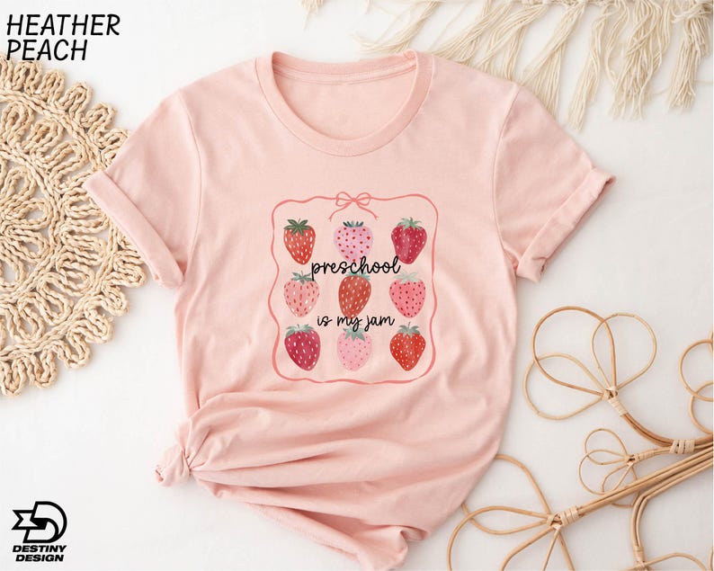 a pink t - shirt with strawberries on it