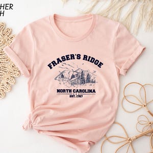 a pink t - shirt with the words fraser's ridge north carolina on