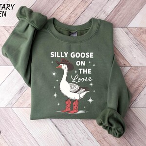 a green sweater with a goose on the side