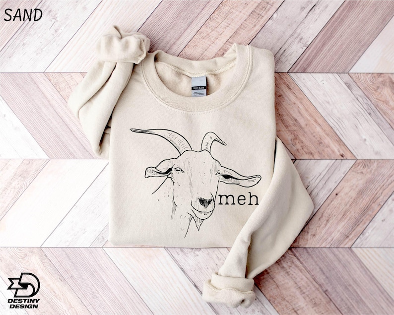 a sweater with a goat on it on a wooden floor