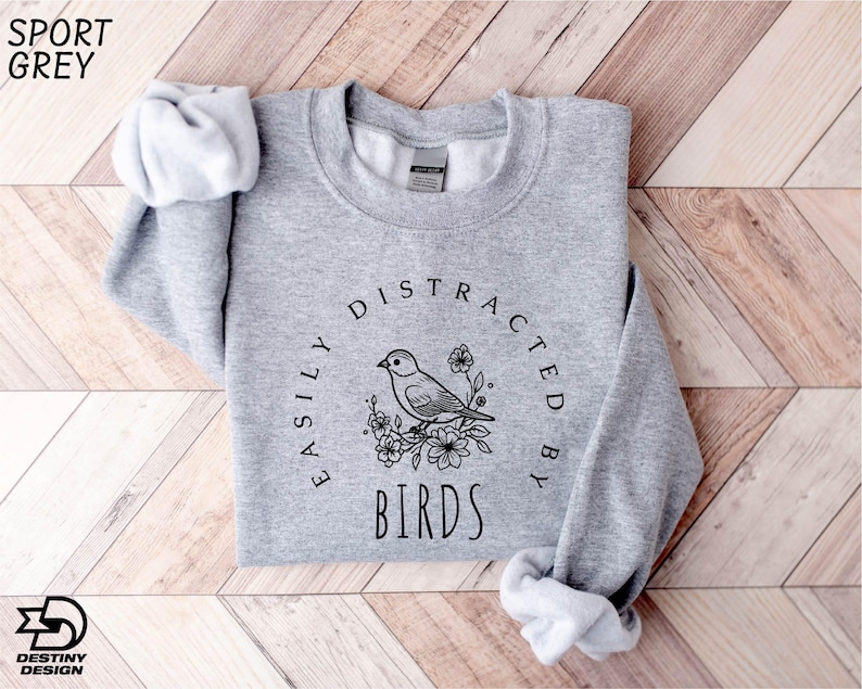 a grey sweatshirt with a bird on it