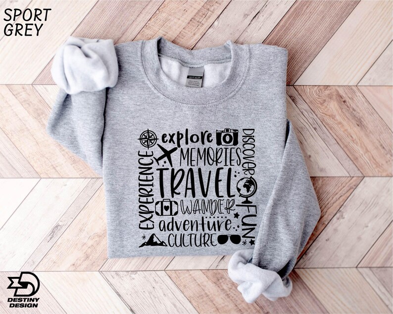 a gray sweatshirt with words on it on a wooden floor