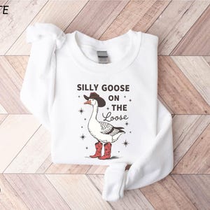 a white shirt that says silly goose on the side