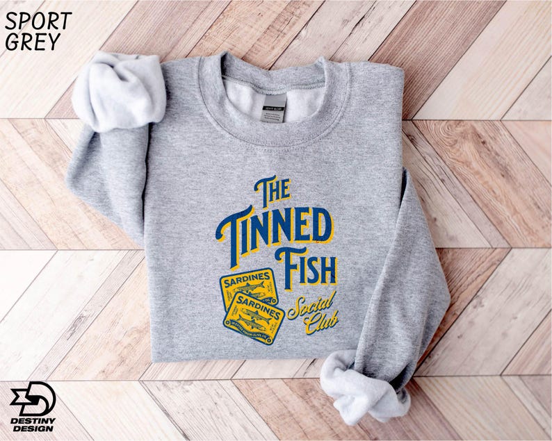 a grey sweatshirt with the words the tinyned fish on it