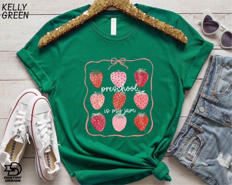 a green t - shirt with strawberries on it