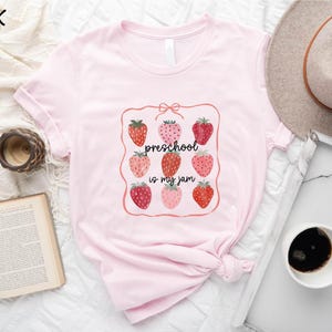 a pink shirt with strawberries on it