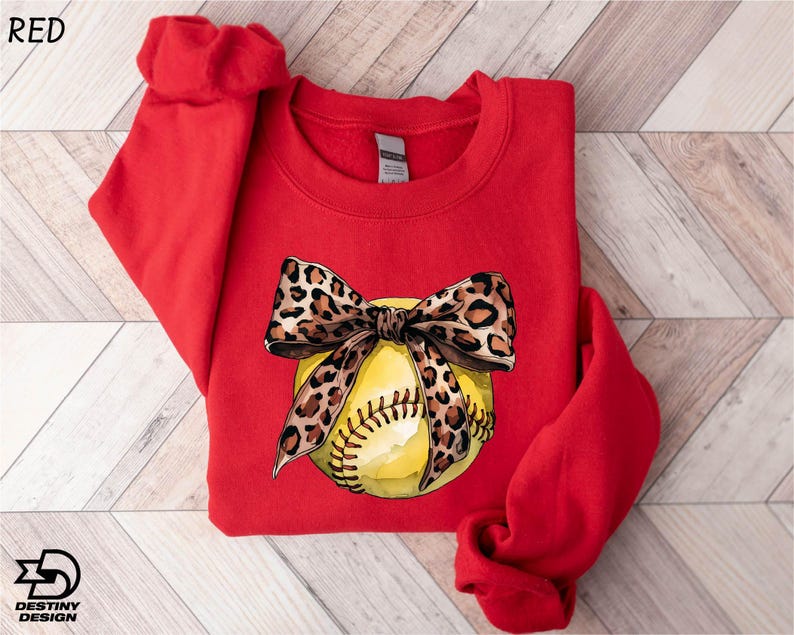 a red shirt with a baseball and a bow on it